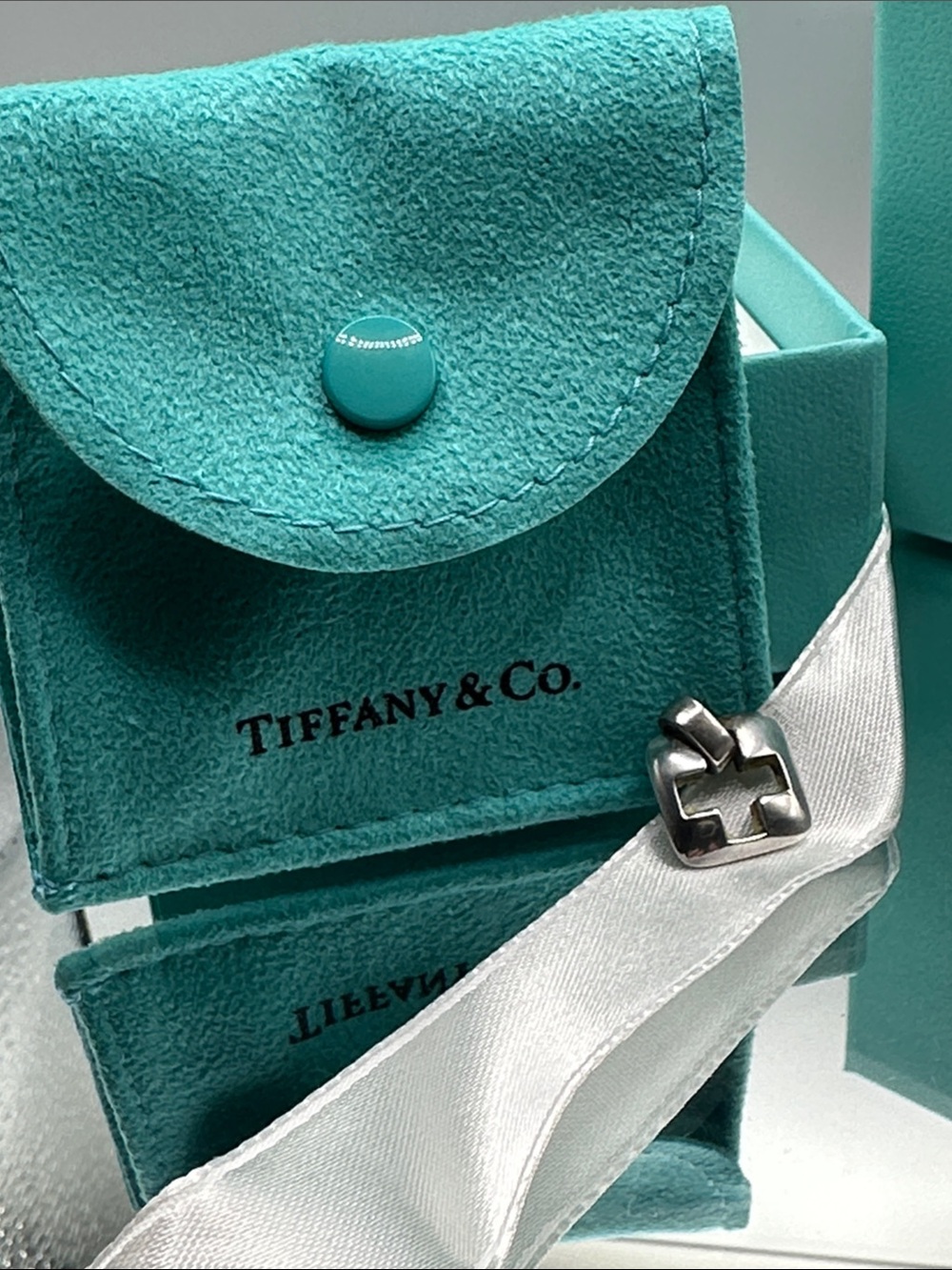 Tiffany & Co. Silver Cross-Link Charm with original box and pouch.
